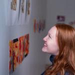 Trinity college student admiring artwork on campus